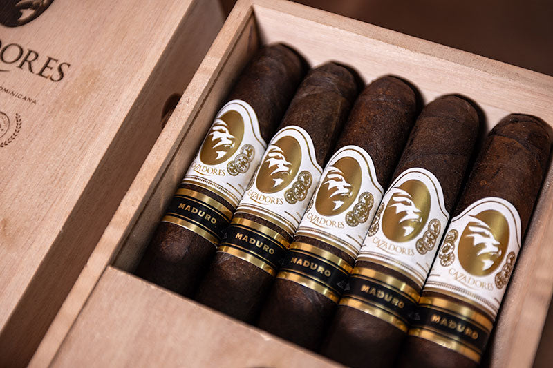 Close-up of La Aurora Cazadores Maduro cigars in the box