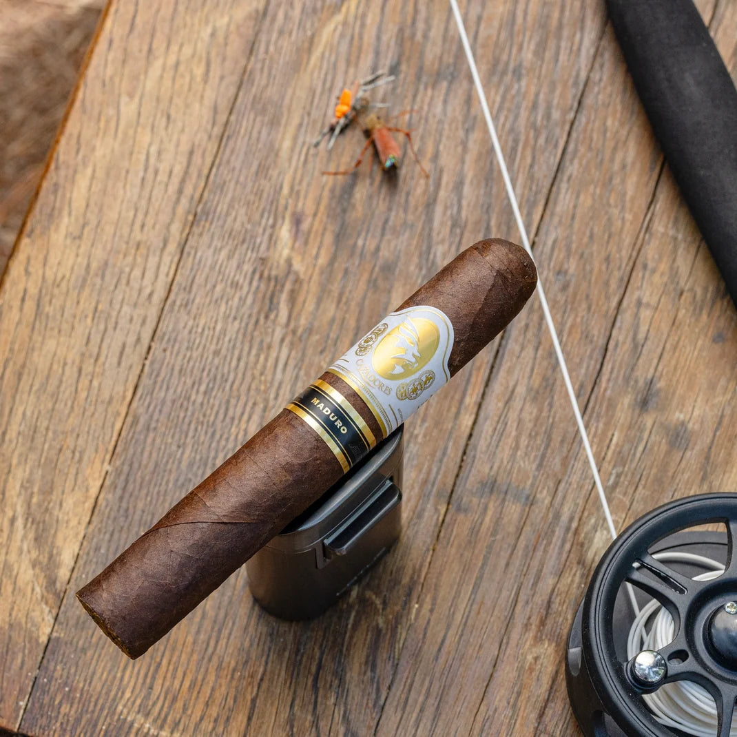La Aurora Cazadores Maduro cigar on a wooden table