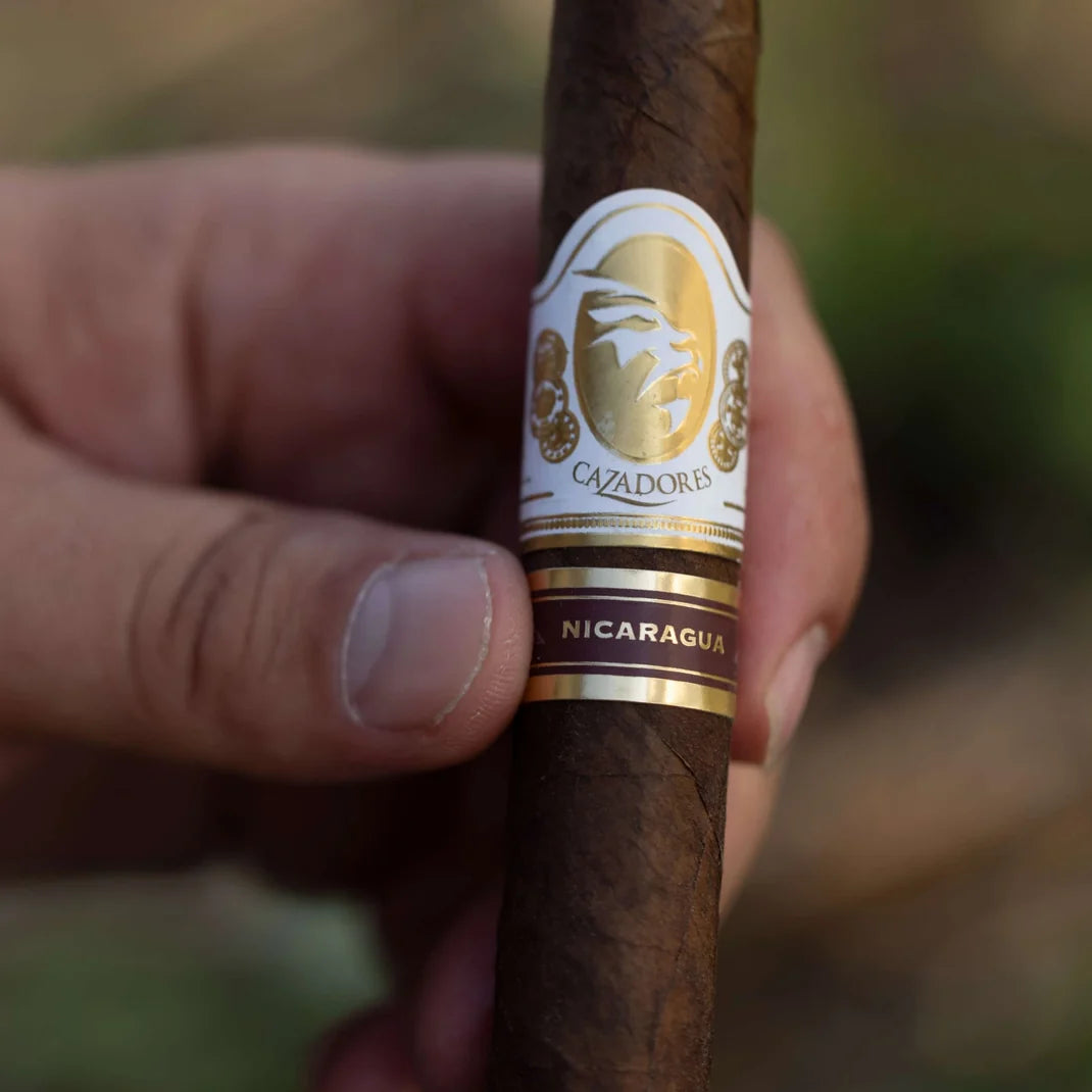 La Aurora Cazadores Nicaragua cigar held in hand outdoors